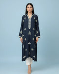 Woman wearing navy embroidered kurta with white trousers and beige heels on blue background