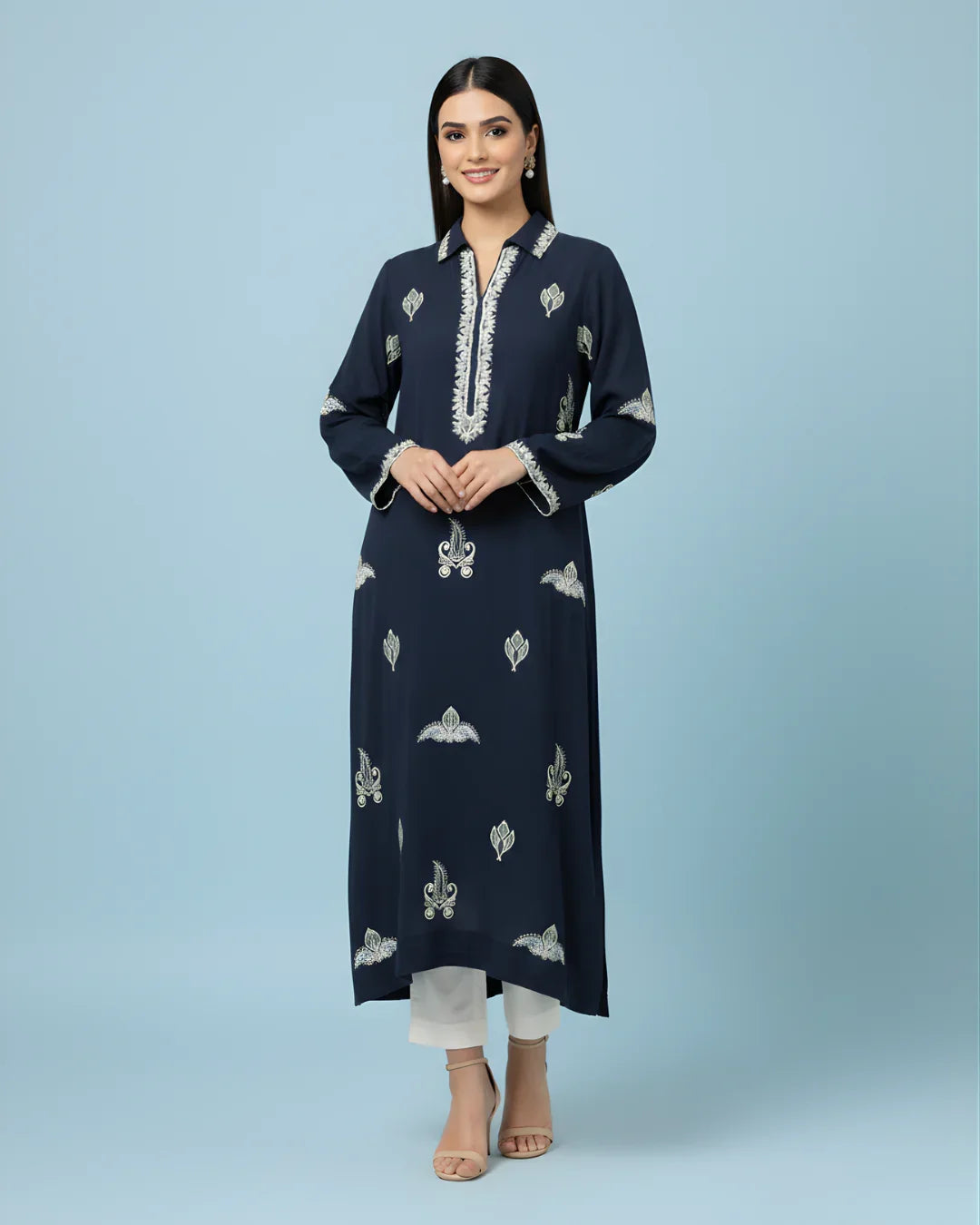 Woman wearing navy blue embroidered kurta with white patterns and white pants