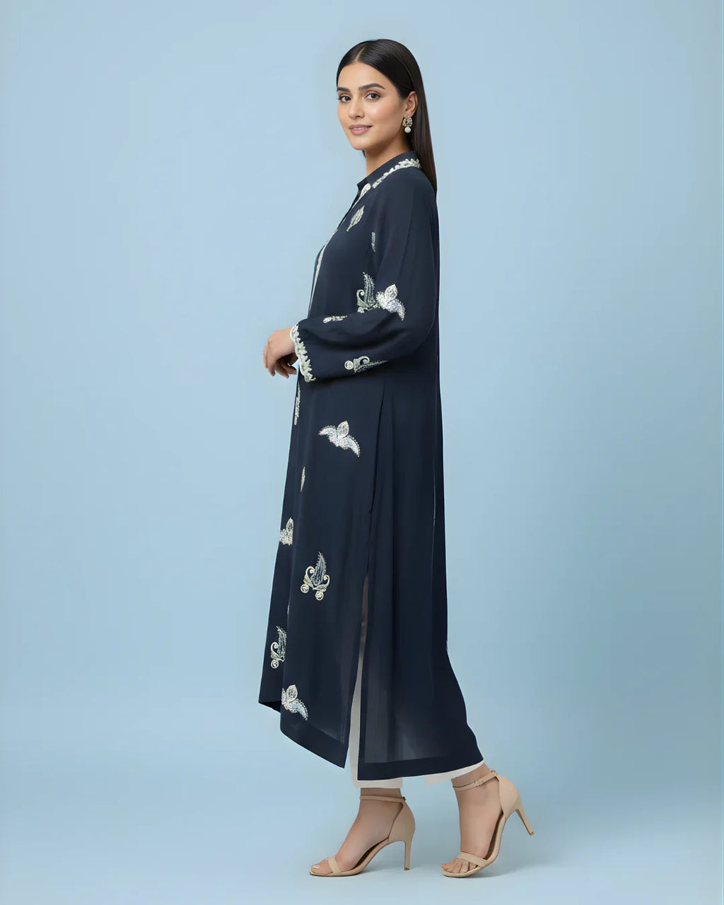 Woman wearing navy blue embroidered kurta with long sleeves and side slit, paired with heels