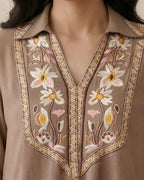 Beige kurta with floral embroidery, V-neck, and intricate threadwork accents.